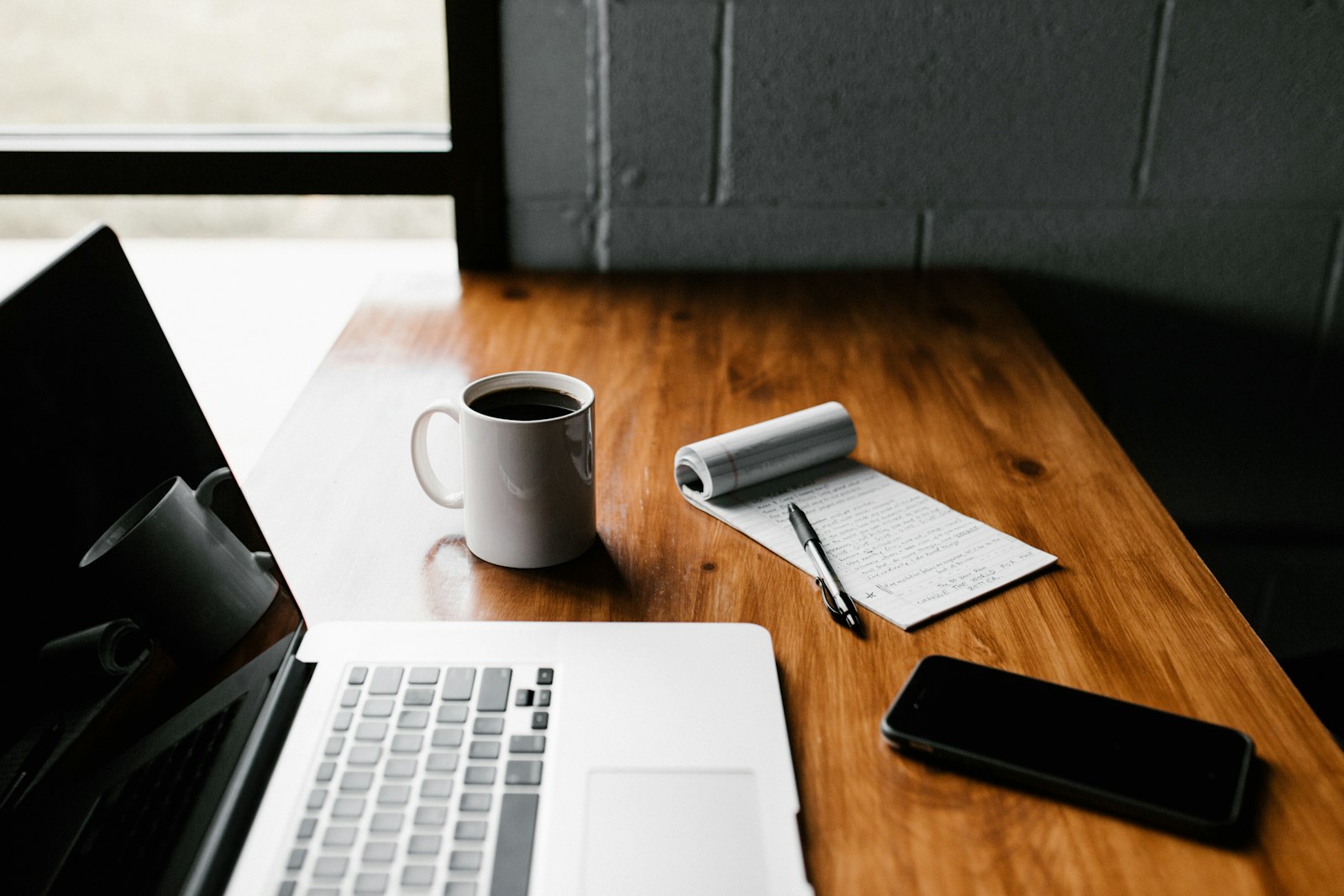 Laptop, coffee and notes on a desk