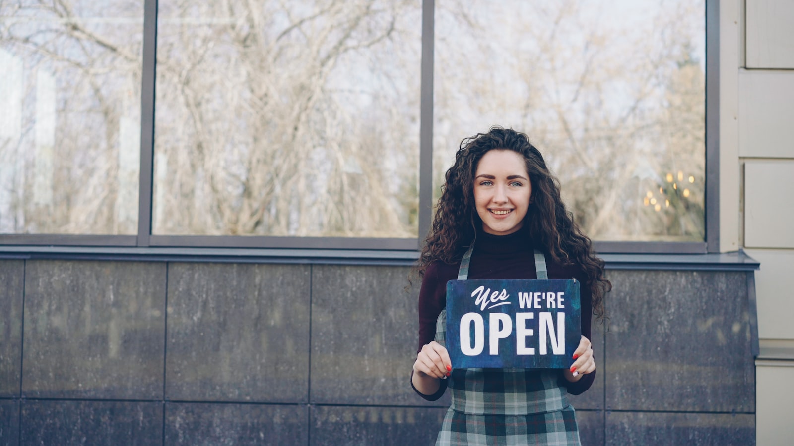 Business owner turning the sign to open